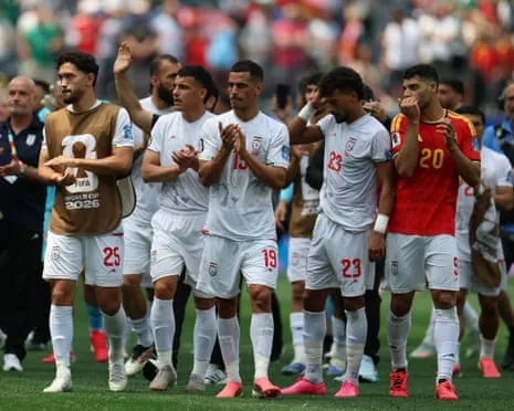 Iran’s players applaud the fans after their defeat to Belgium